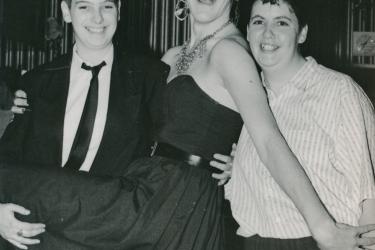 Three members of the Greenwich Lesbian and Gay Centre celebrating and posing at a 21st birthday party, 1989