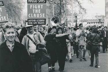 Marchers in a Stop the Clause demonstration in London with placards 'NALGO says fight the clause. Defend Lesbian and Gay Rights', and a brass band,  1988