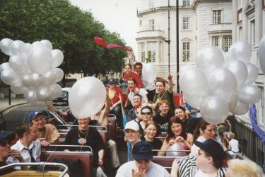 Young people with balloons on the top deck of The Metro Centre bus