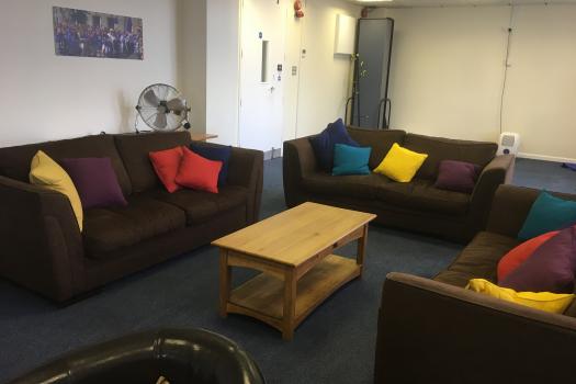 METRO Woolwich - Main Room - Three sofas with colourful cushions around a coffee table