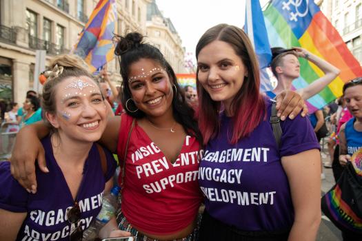 METRO staff wearing purple and red t-shirts at Pride in London