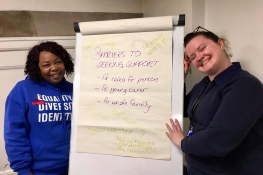 Betty delivering a workshop on barriers seeking to support for HIV at the CHIVA conference wearing a blue METRO hoodie