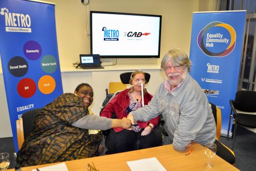 Gwen, Sue and John at our merger agreement signing