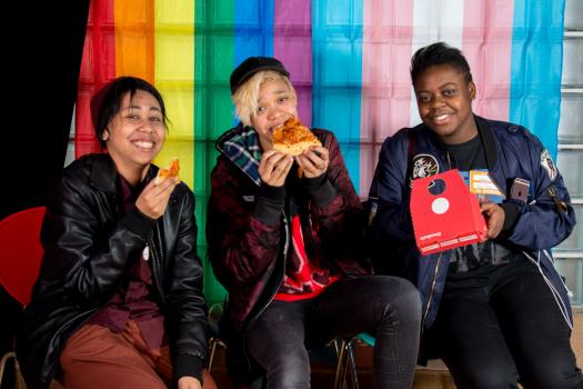 Young people eating pizza at the METRO Youth Summit in Southwark in 2018