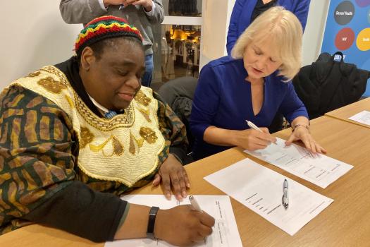 Our Chair, Gwen Bryan, and SPH's Chair Heather Loxley signing the merger agreement