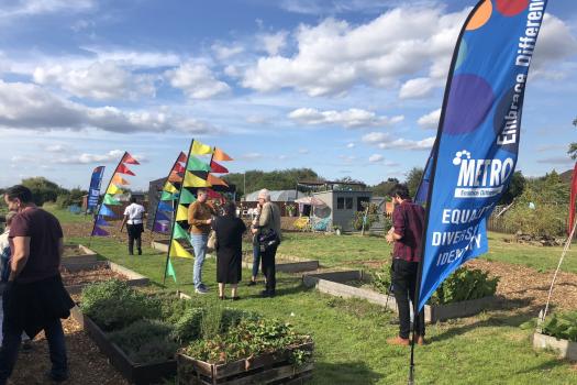 Allotment launch with guests and colourful flags