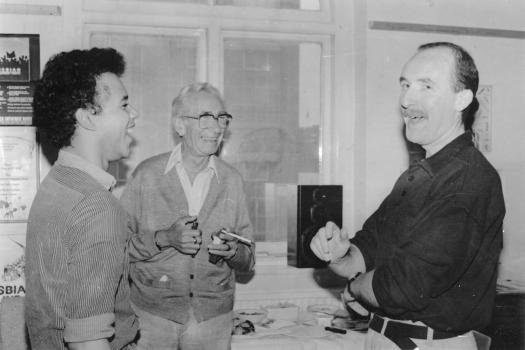 Three men laughing together at the Greenwich Lesbian and Gay Centre, 1989