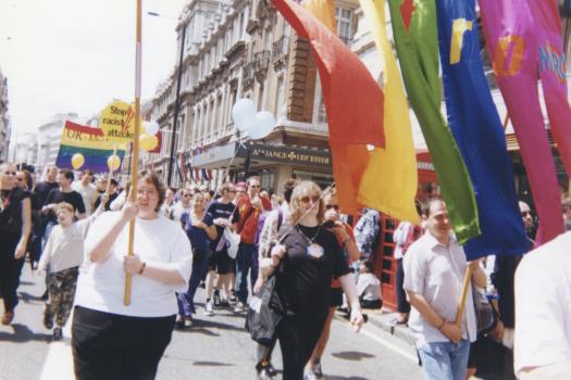 Marchers holding Metro rainbow banner at central London Pride, 1998