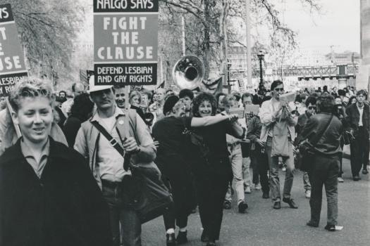 Marchers in a Stop the Clause demonstration in London with placards 'NALGO says fight the clause. Defend Lesbian and Gay Rights', and a brass band,  1988