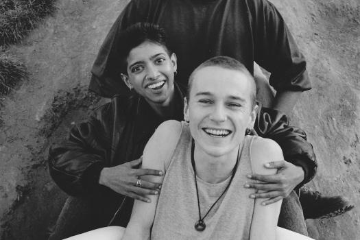 Four staff/collaborators on the Metro Thrust project smiling and posing at the bottom of a slide, 1994