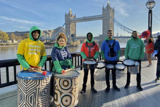 METRO with people from South London Samba drumming in front of London Bridge and the Thames