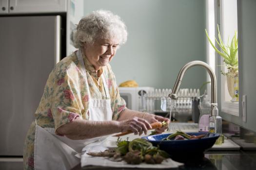 elderly woman washing produce