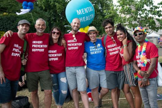 Group of people outside with red t-shirts saying 'Insight Prevention Support'