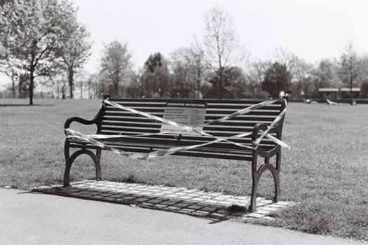 Photo of a park bench tapes off