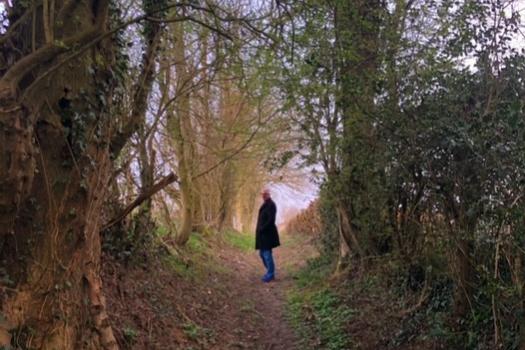 Greg's husband Warren in the autumn woods