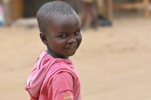 Black African child head and shoulders outdoors