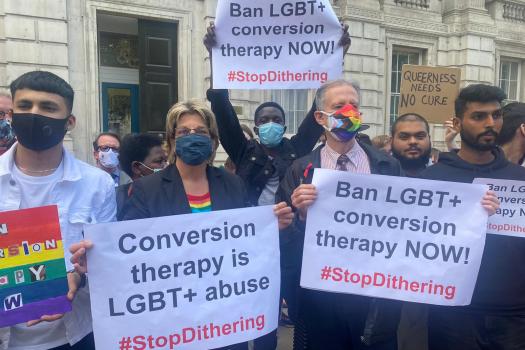 Protesters including Peter Tatchell holding placards with Ban conversion therapy now #StopDithering and Conversion therapy in LGBT+ abuse