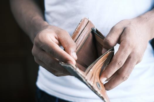 A person holding empty wallet open