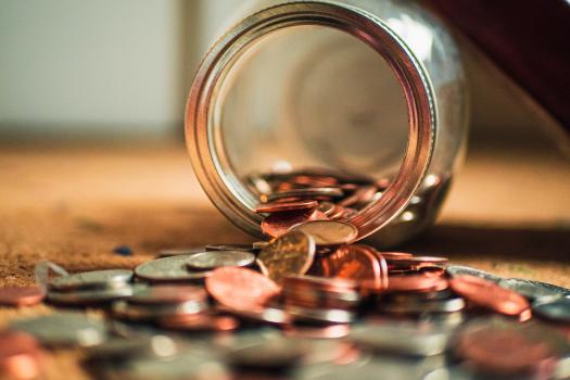 Photo of jar of coins spilling out